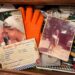 Open junk drawer filled with everyday tools and household clutter, with a wedding photo of the author and her grandmother, a childhood pony photo, and a handwritten family recipe card tucked among the items